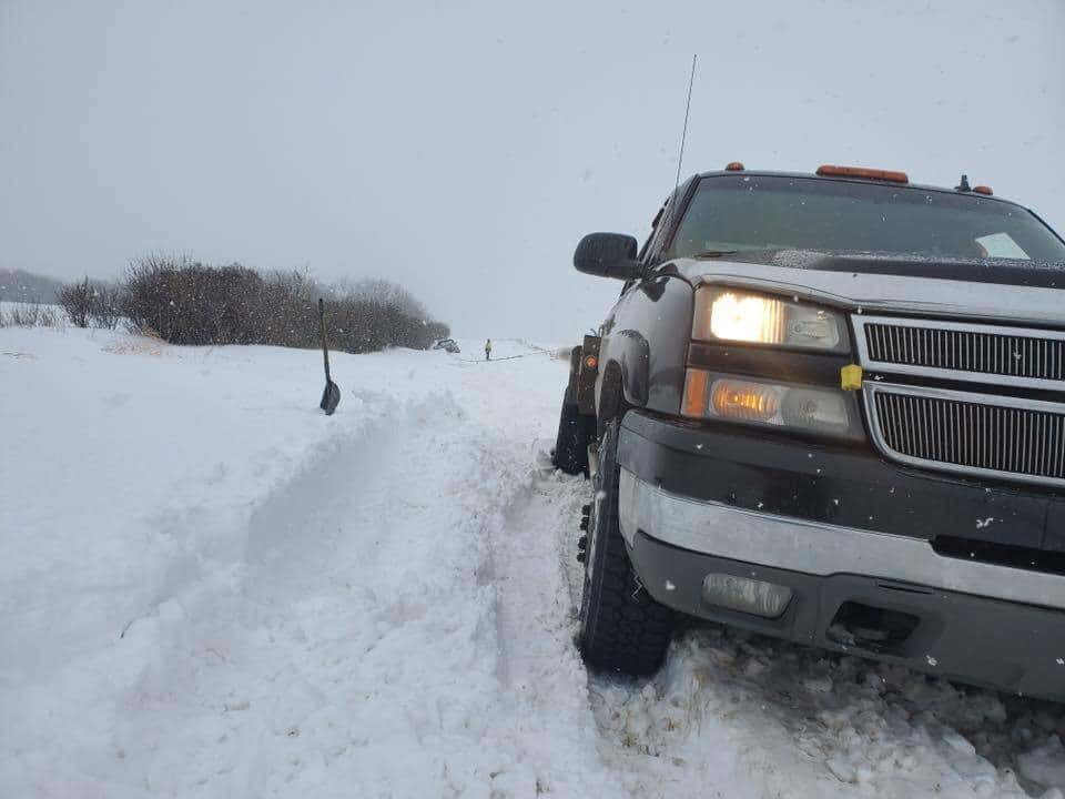 Bro's Tows truck performing blizzard winch recovery in Saskatchewan snow