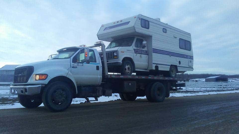 Bro's Tows F-750 deck truck hauling a camper motorhome