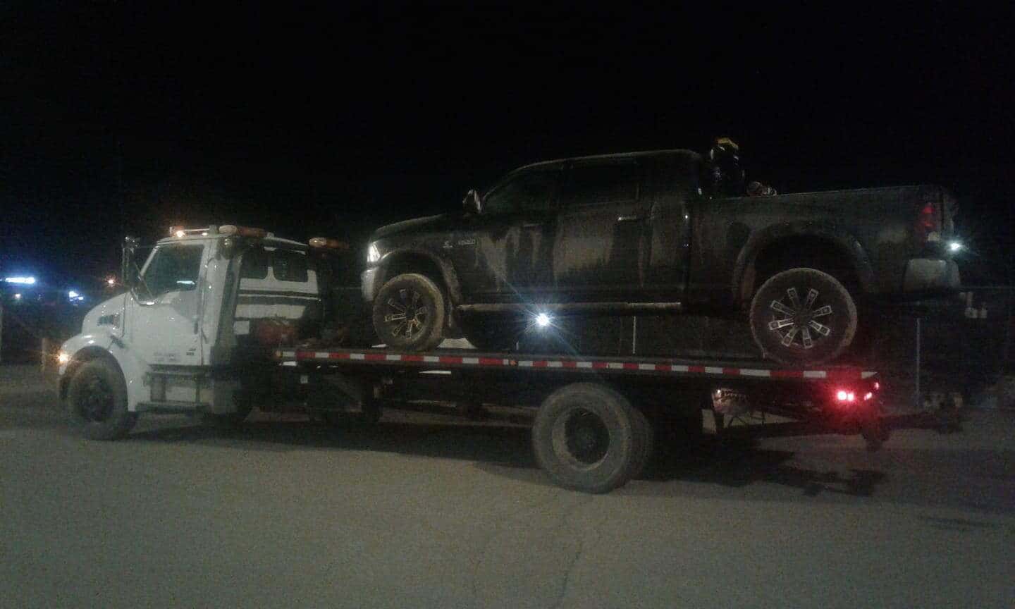 Bro's Tows flatbed towing at night in Saskatchewan