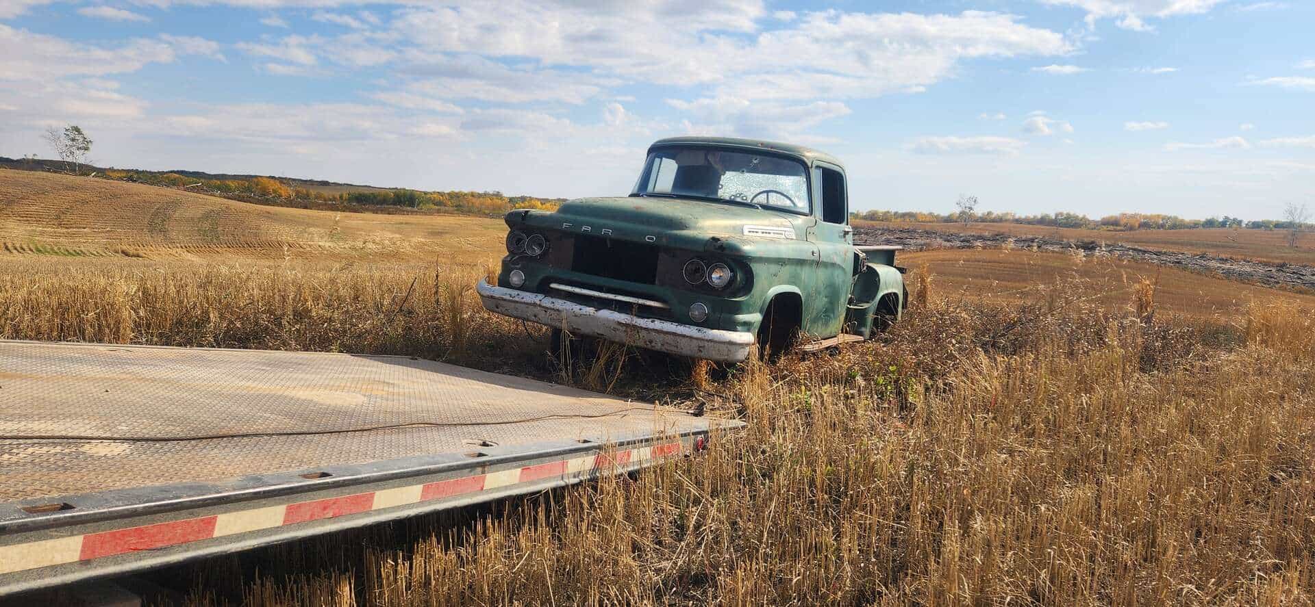 Vintage truck in a Saskatchewan prairie field with Bro's Tows flatbed